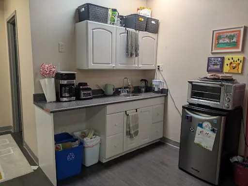 The Burrow's kitchenette with a sink, fridge, and convection oven