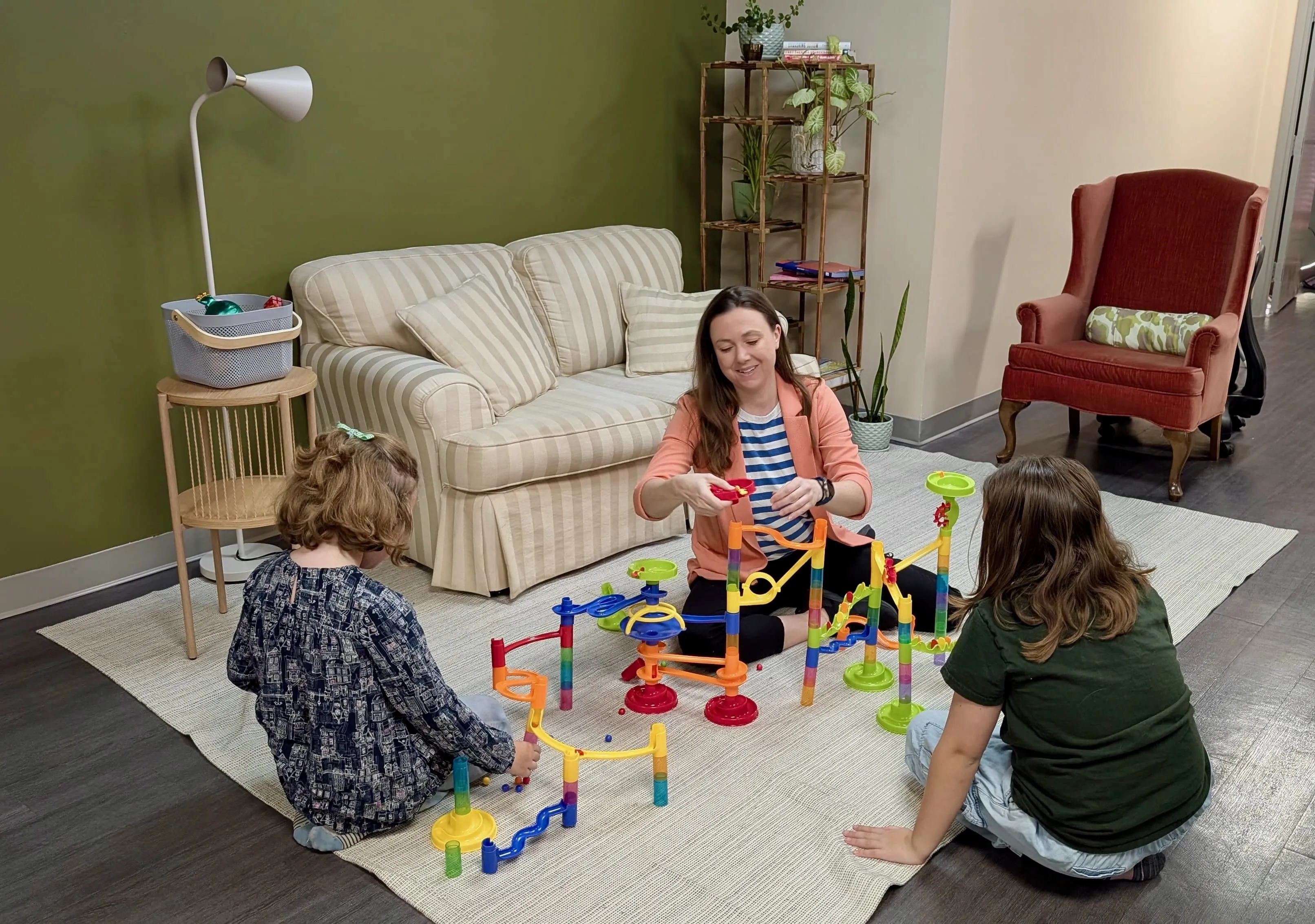 Children use small pieces while building a marble run at Together OT