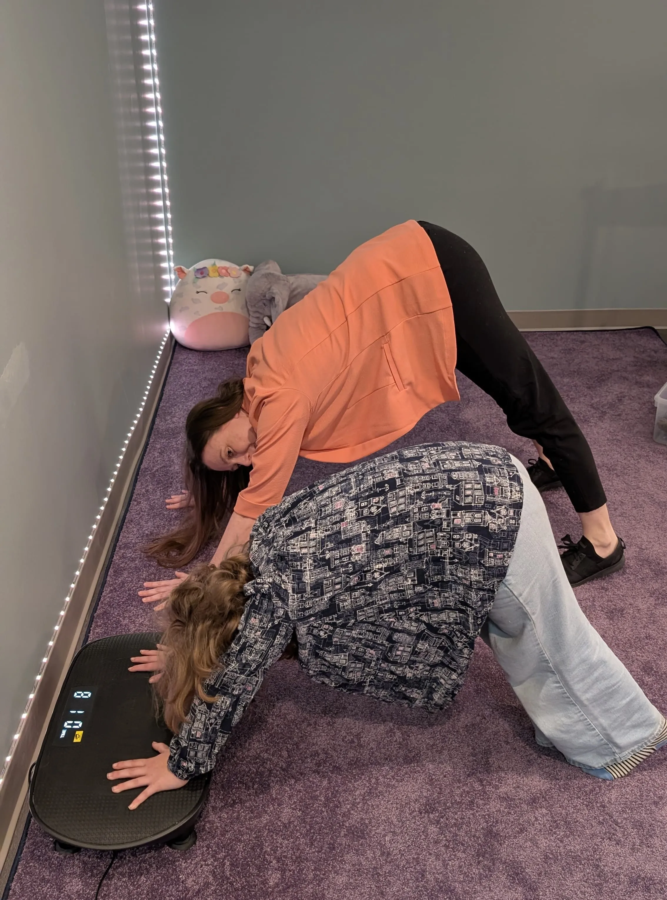 Heather and a child use movement equipment in the Burrow's calm, flexible space